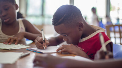 Boy writing on paper