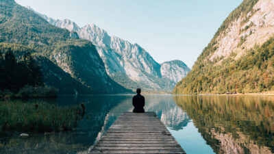 Man sitting on grey dock