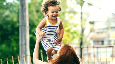 Woman lifting child